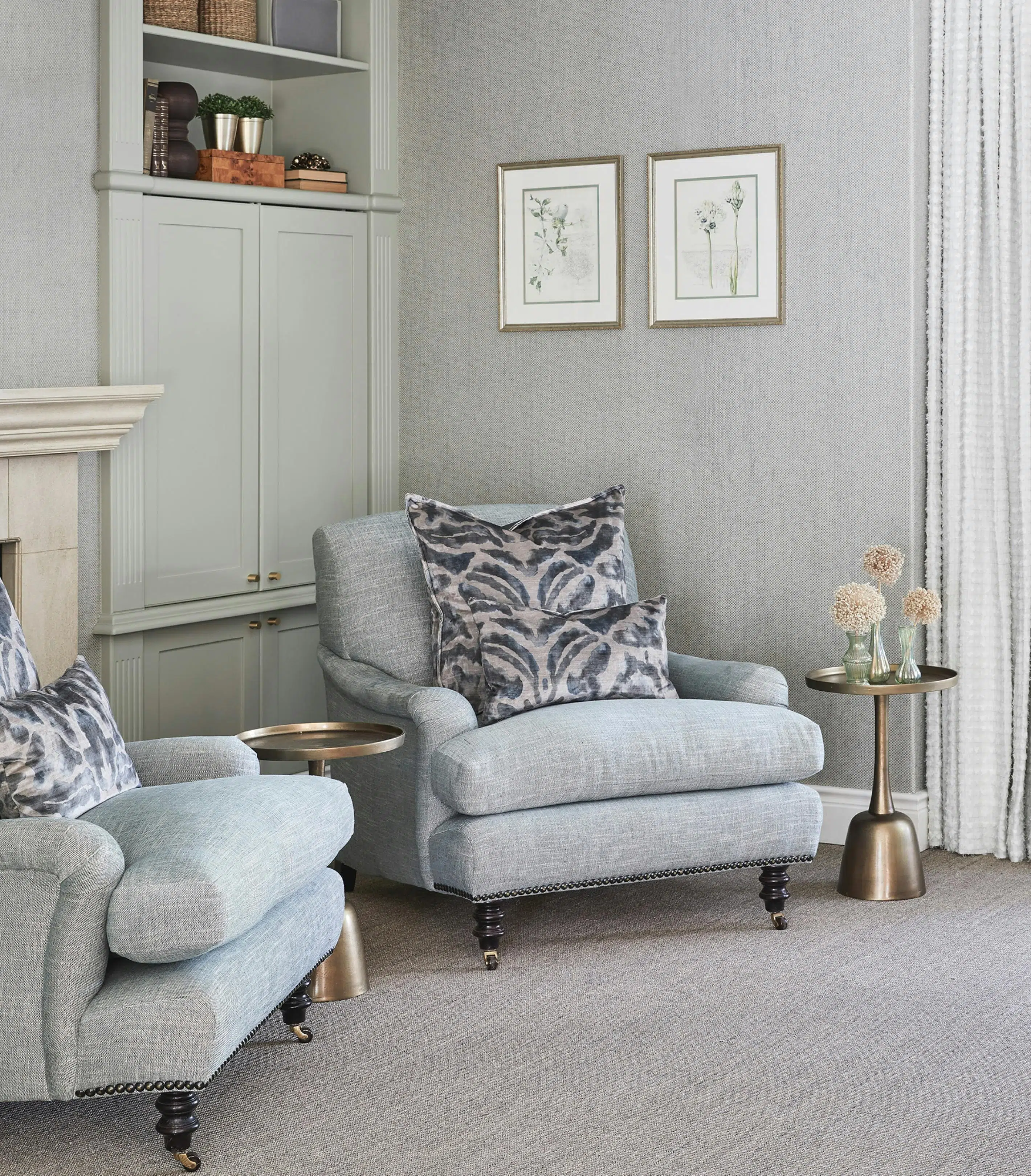 A reading nook with two armchairs and two side tables.