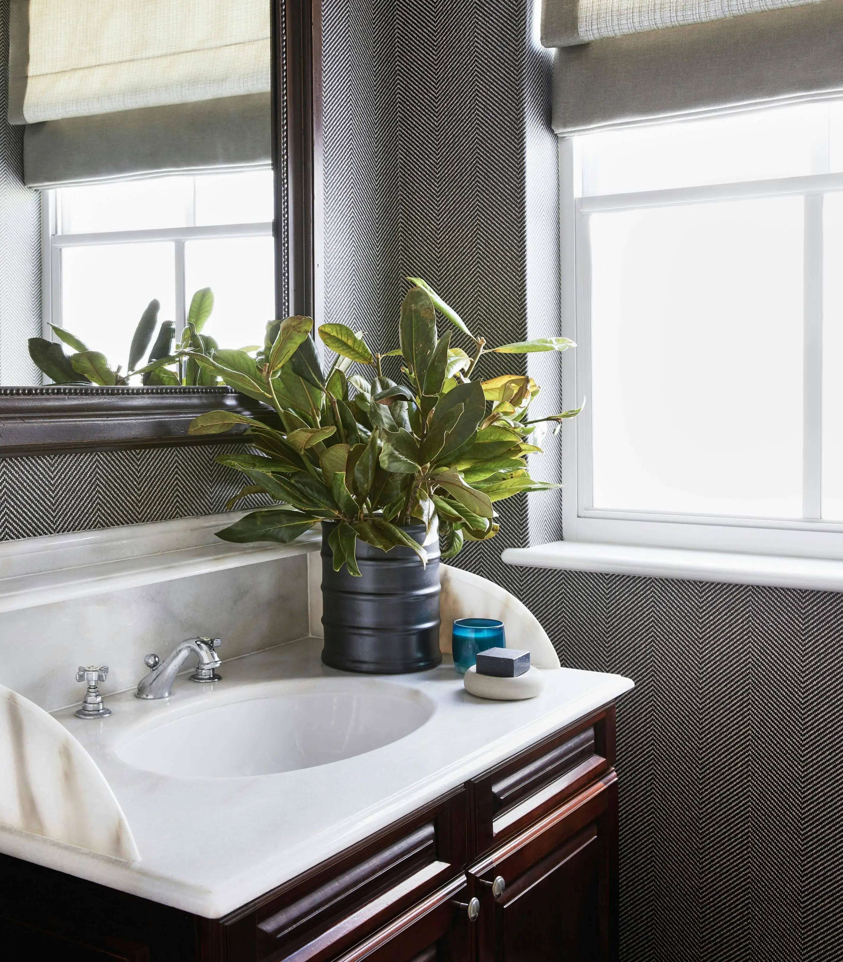 Close-up of a bathroom basin with a mirror on the wall.